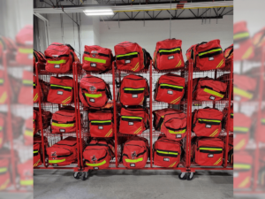 Large rack of red and fluorescent yellow firefighter bags