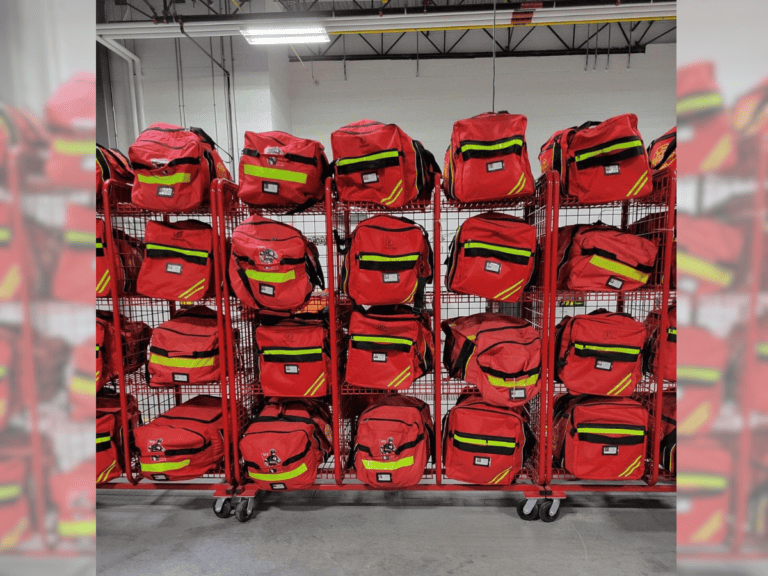 Large rack of red and fluorescent yellow firefighter bags